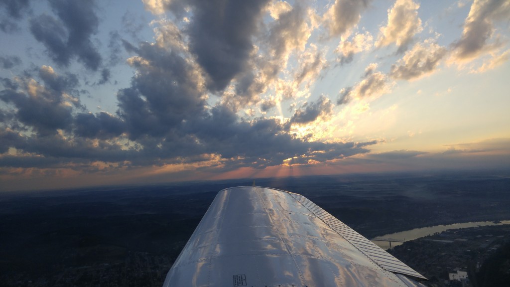 Sun breaking through the clouds off the right wing